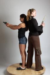 OXANA AND XENIA STANDING POSE WITH GUNS